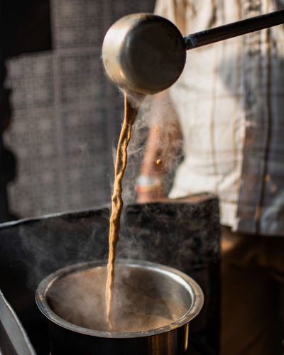 Close-up of tea pouring in vessel 