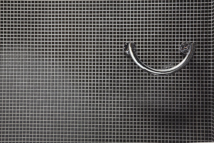 Close-up of metal equipment on wall in domestic bathroom
