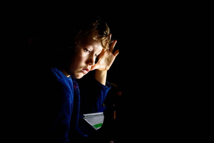 Close-up of boy in darkroom