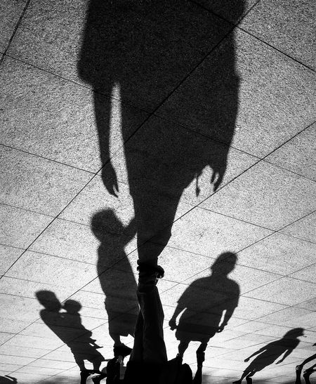 Shadow of people standing on ground