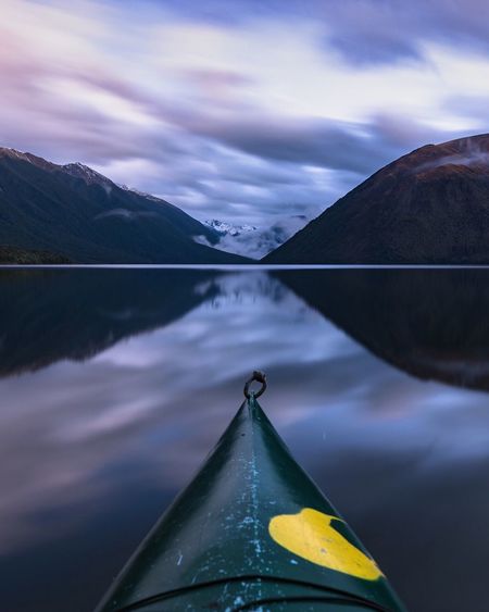 Cropped image of kayak in river at dusk