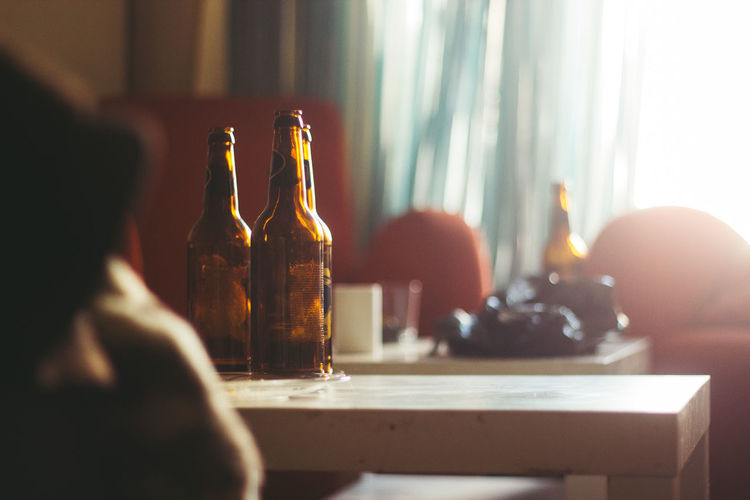 Beer bottles on table in room