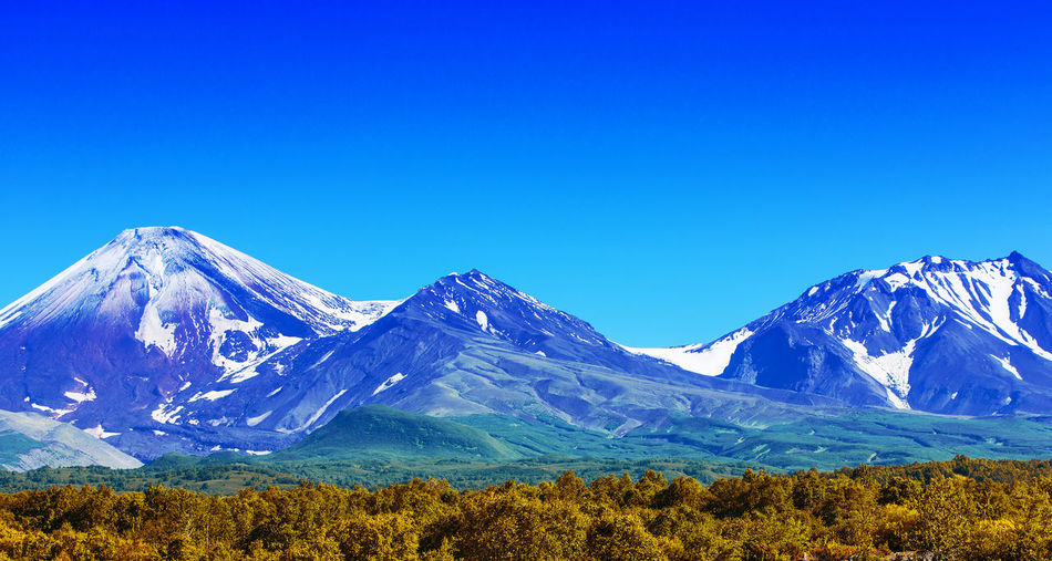 The avachinsky and kozelsky volcanoes in kamchatka in the autumn with a snow-covered top