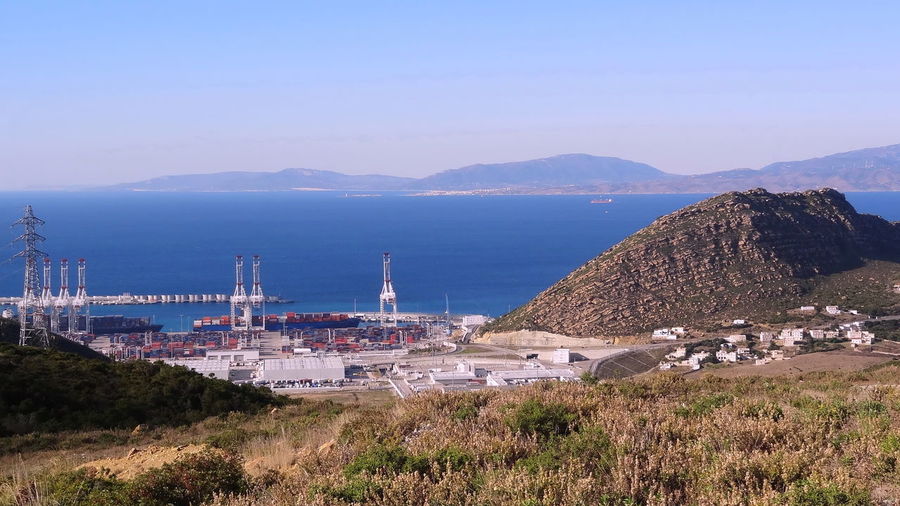 High angle view of sea and mountains against sky