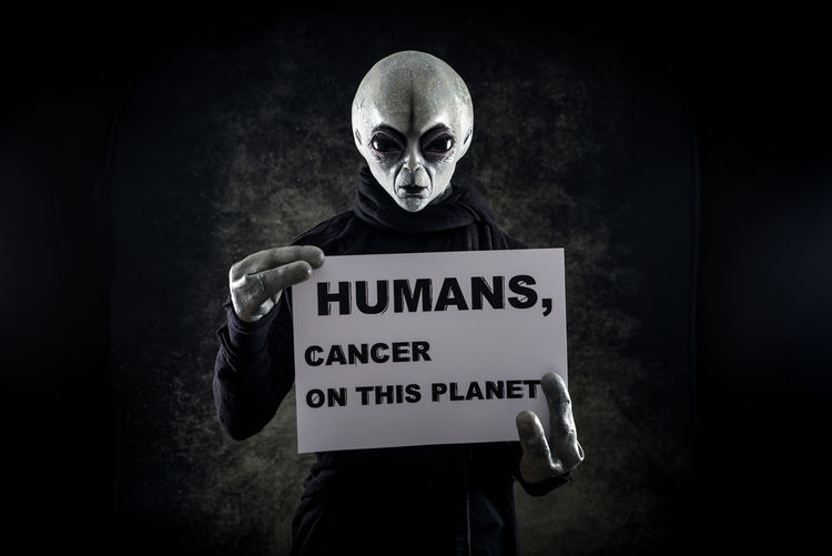 Portrait of alien with text against black background