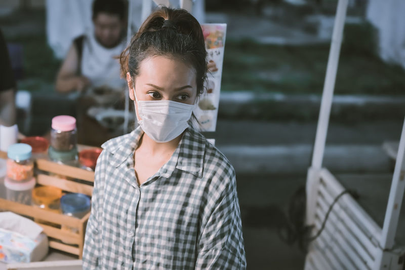 Series photo of young woman tourist wear surgical medical mask touring in street night market