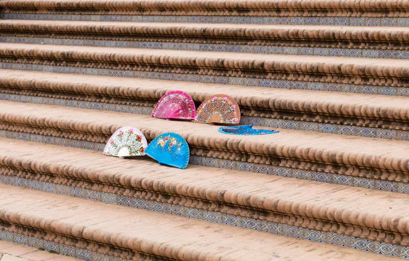 Close-up of multi colored fans on stairs