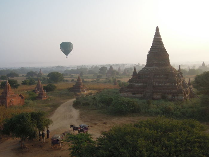 Panoramic view of temple against sky and balloon
