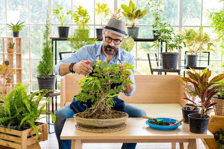 Portrait of senior man gardening at home