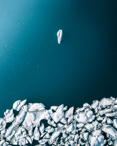High angle view of icebergs floating on sea during winter
