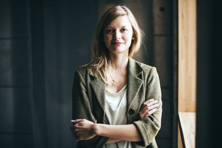 Portrait of mid adult woman smiling by window