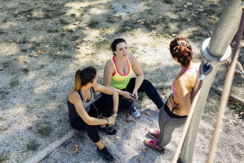 Female friends resting after training in park