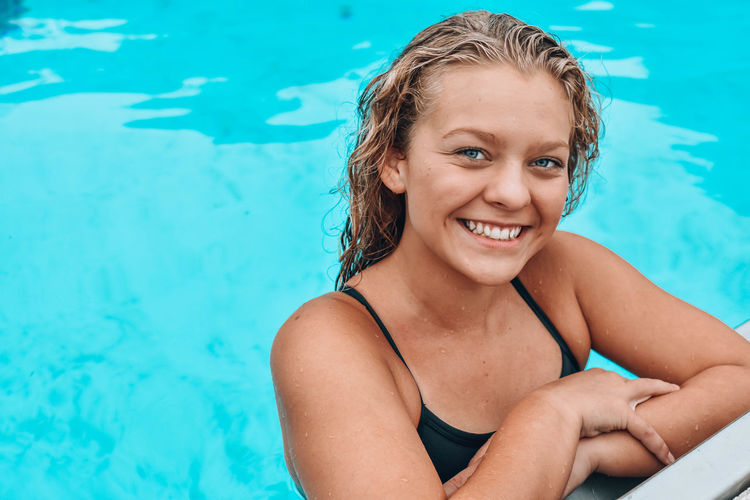 Portrait of smiling young woman in swimming pool