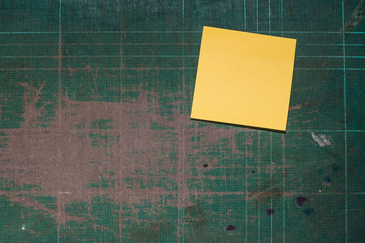 Close-up of blank yellow notes on wall