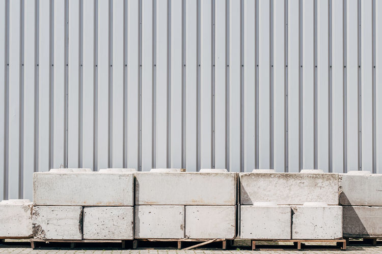 Concrete street barrier in front of wall
