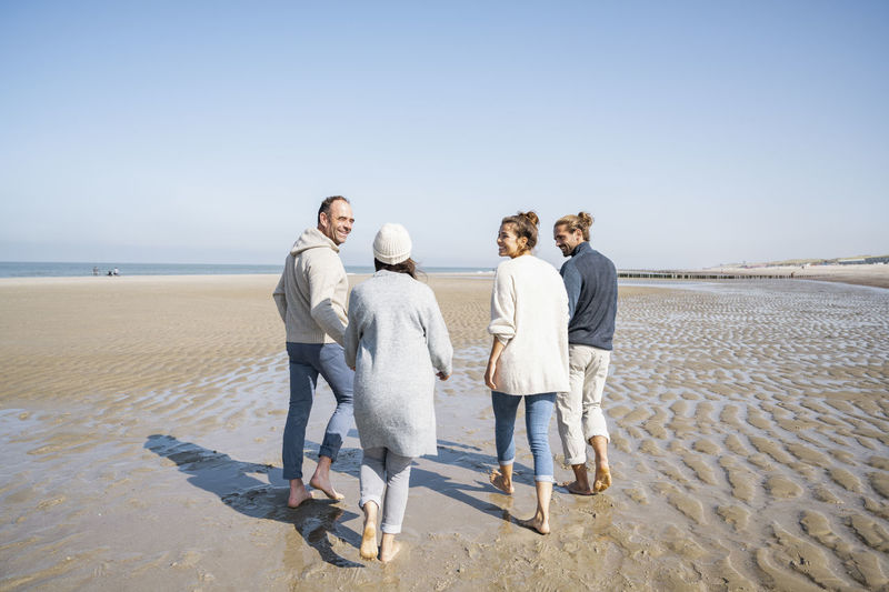 Happy family walking together at beach