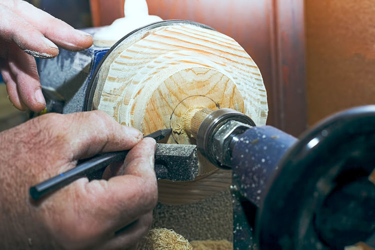 Cropped hands of carpenter holding work tool