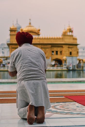 Rear view of man and woman at golden temple in city