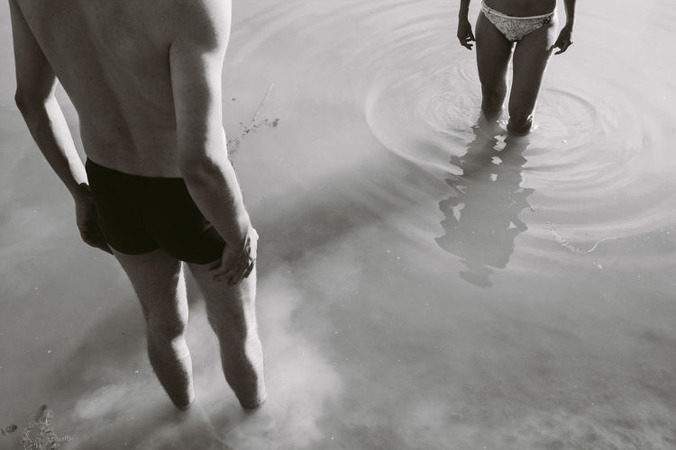 Low section of people / couple standing in water