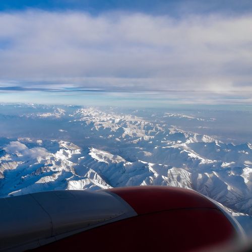 Aerial view of clouds over mountains seen from airplane