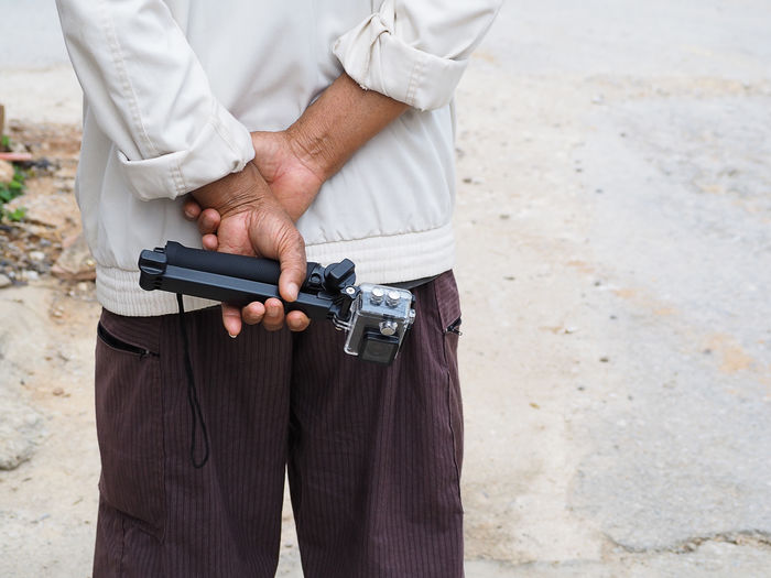 Close-up of man holding wearable camera