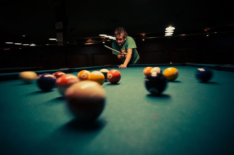 Man playing pool at night