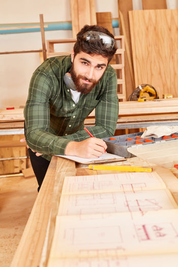 Portrait of man working on table