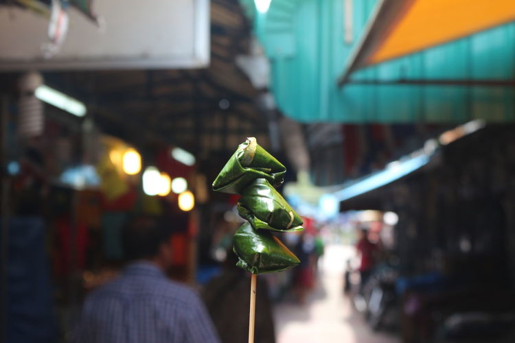 Close-up of paan against crowd at market