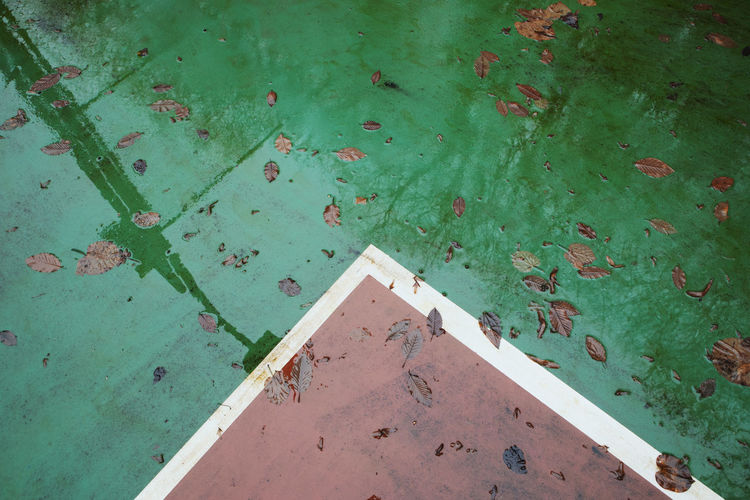 High angle view of leaves on wet court