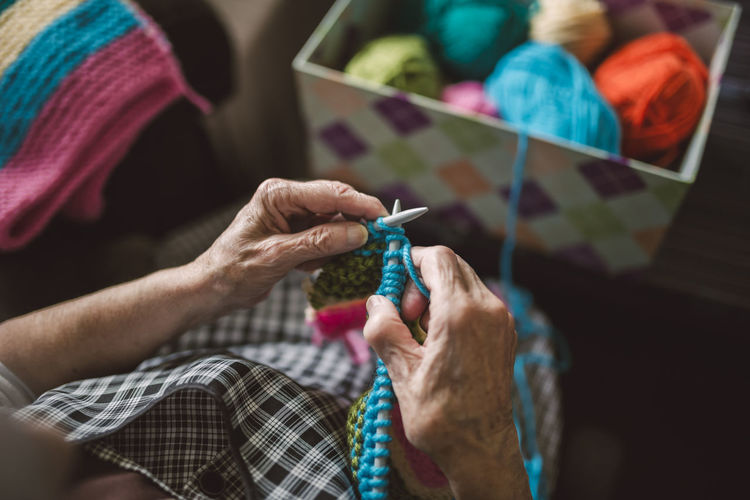 Hands of knitting senior woman, close-up