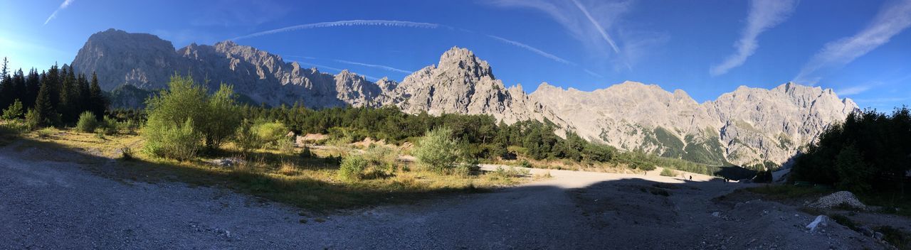 Panoramic view of mountains against blue sky