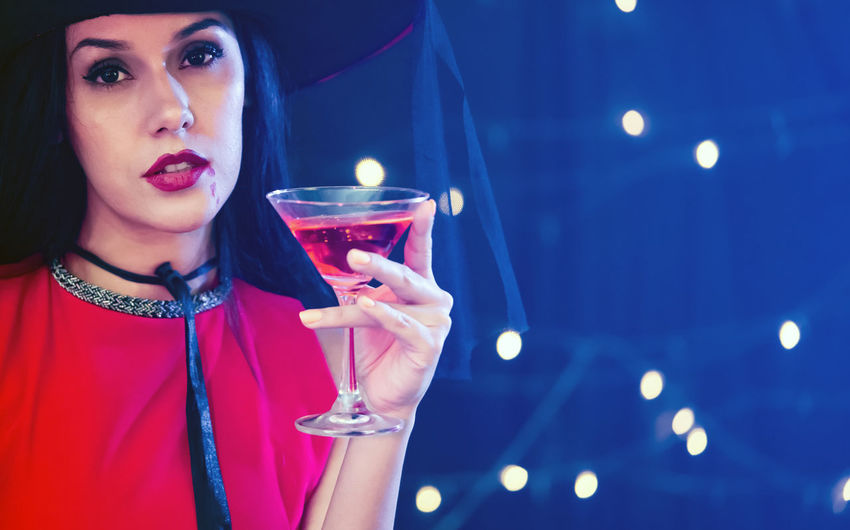 Portrait of young woman drinking glass