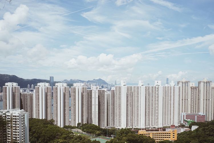 Skyscrapers against cloudy sky