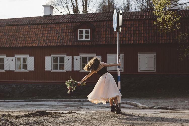 Woman standing near road sign