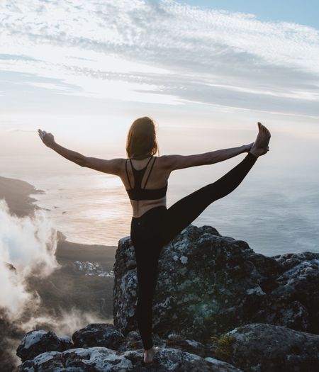 Woman doing yoga on mountain