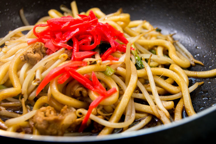 Close-up of udon noodles in cooking pan