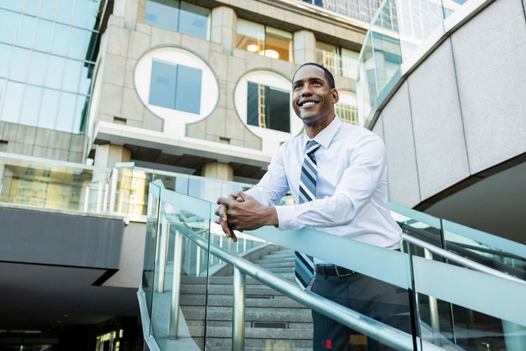 Portrait of businessman standing in city