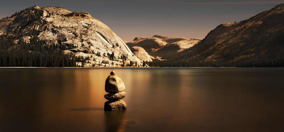 Stacked stones on calm lake against mountains at yosemite national park