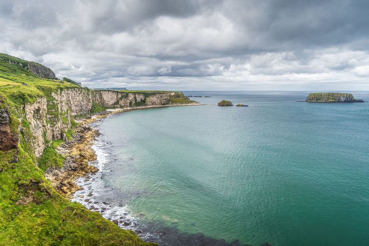 Coastline with limestone cliffs and sheep island, near carrick a rede rope bridge, northern ireland