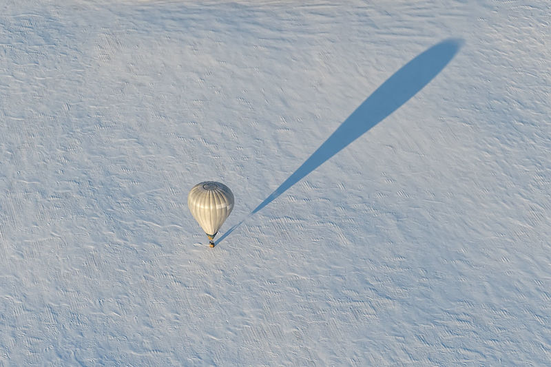 High angle view of hot air balloon on snow covered land