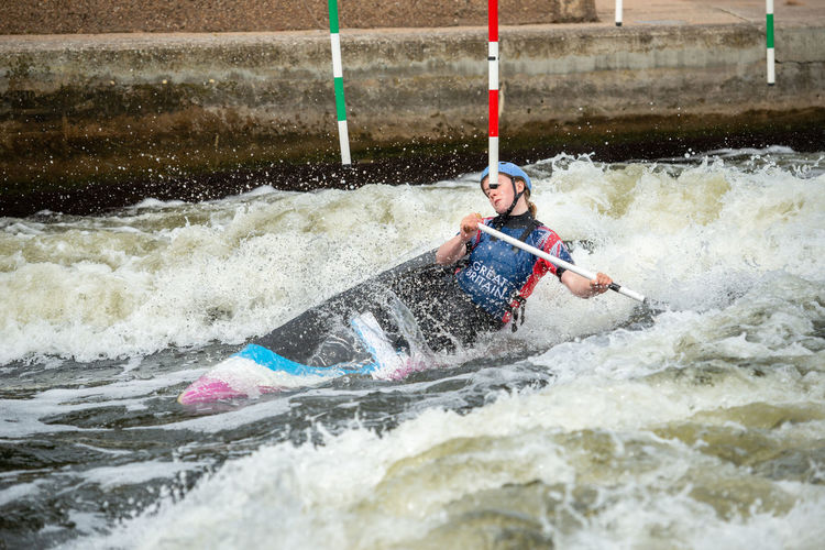 Man surfing on boat in river