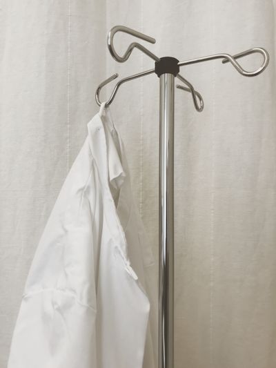 Close-up of lab coat hanging on rack
