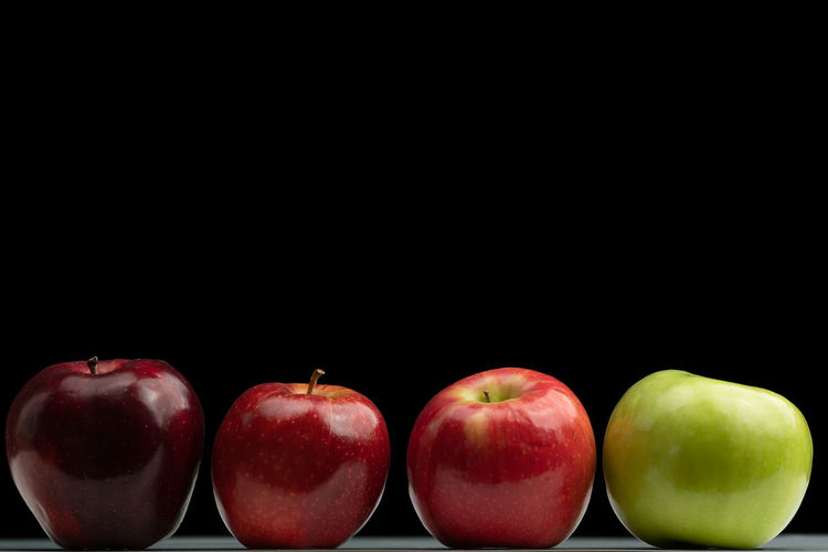 Close-up of apples against black background