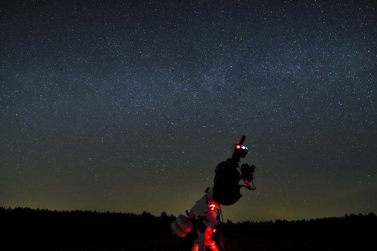 Telescope against star field at night