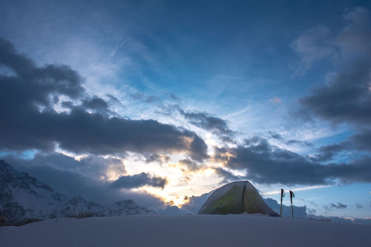 Tent in snow at sunrise, high altitude camping in nepal