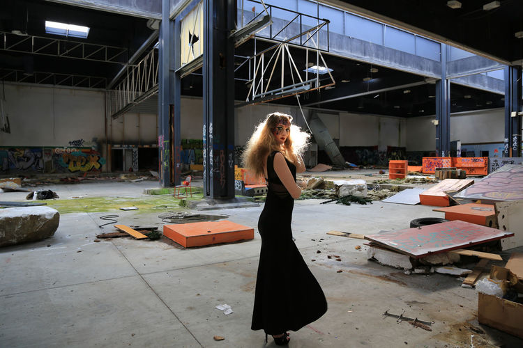 Beautiful woman standing in abandoned building