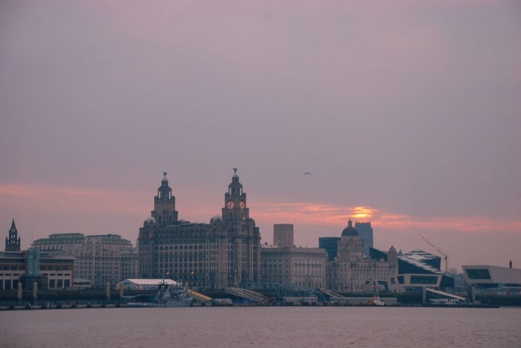 The iconic liver building on the waterfront next to the river mersey in liverpool. uk