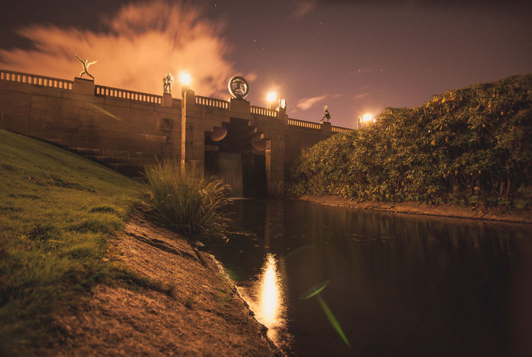 Bridge in vigeland sculpture park against sky at night