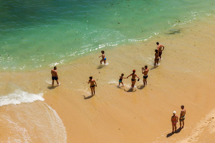 High angle view of people walking on beach