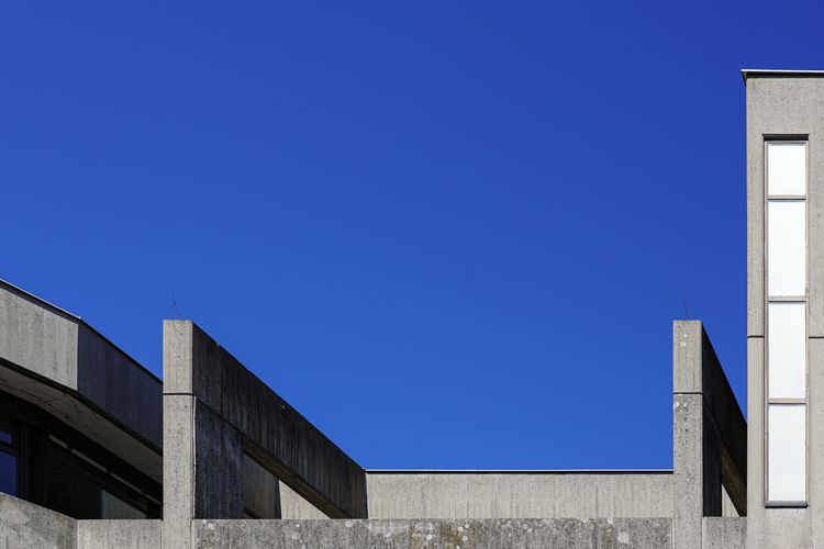 Low angle view of brutalist building against clear blue sky